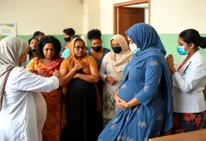 Pregnant women receiving vaccinations at a health clinic.