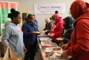 Volunteers serving meals at Open Door Feeding Ministry