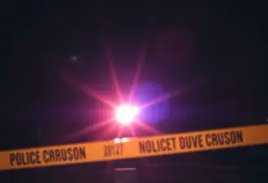 Police lights illuminating an apartment complex at night in Lexington, Kentucky.