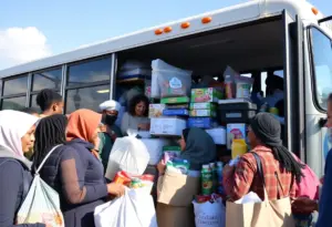 Community members donating items to the Stuff the Bus initiative in Lexington