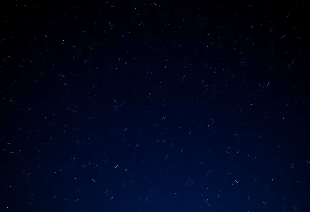 Night sky during the Geminid meteor shower with shooting stars