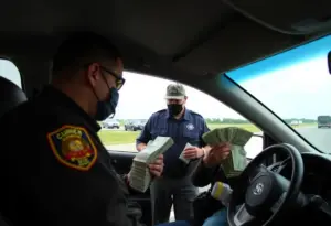 U.S. Customs and Border Protection officers at a border checkpoint in Lexington, Kentucky, during a cash seizure operation.