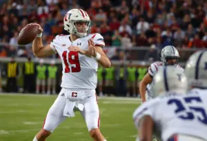 Quarterback executing a pass during a college football game